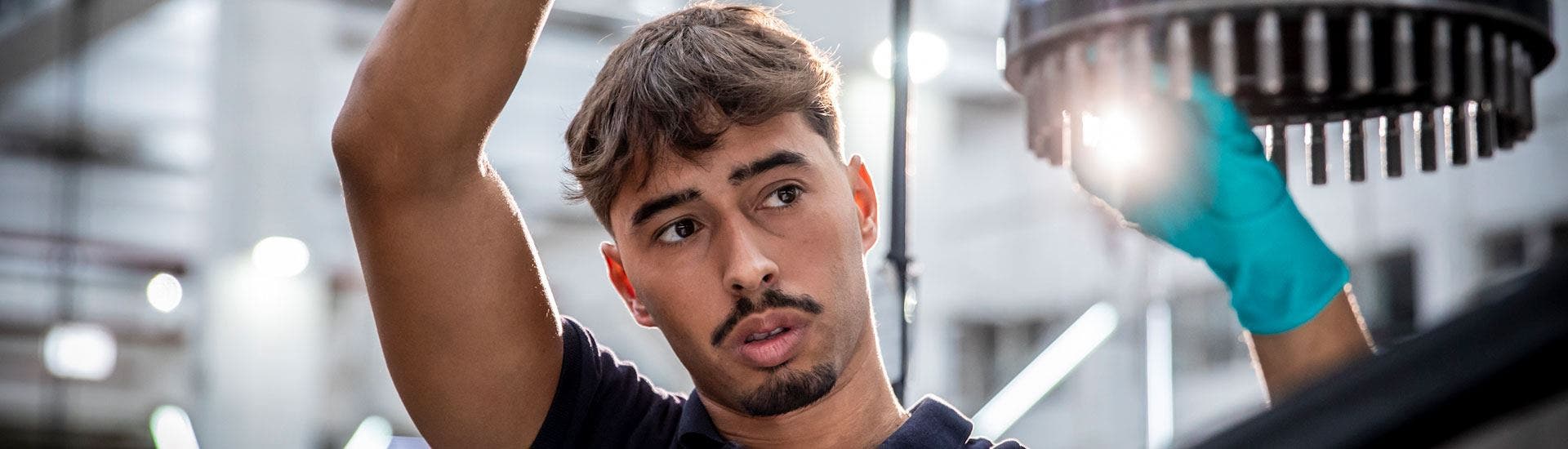 Young TAP Maintenance worker focused on his task in an aerospace environment.